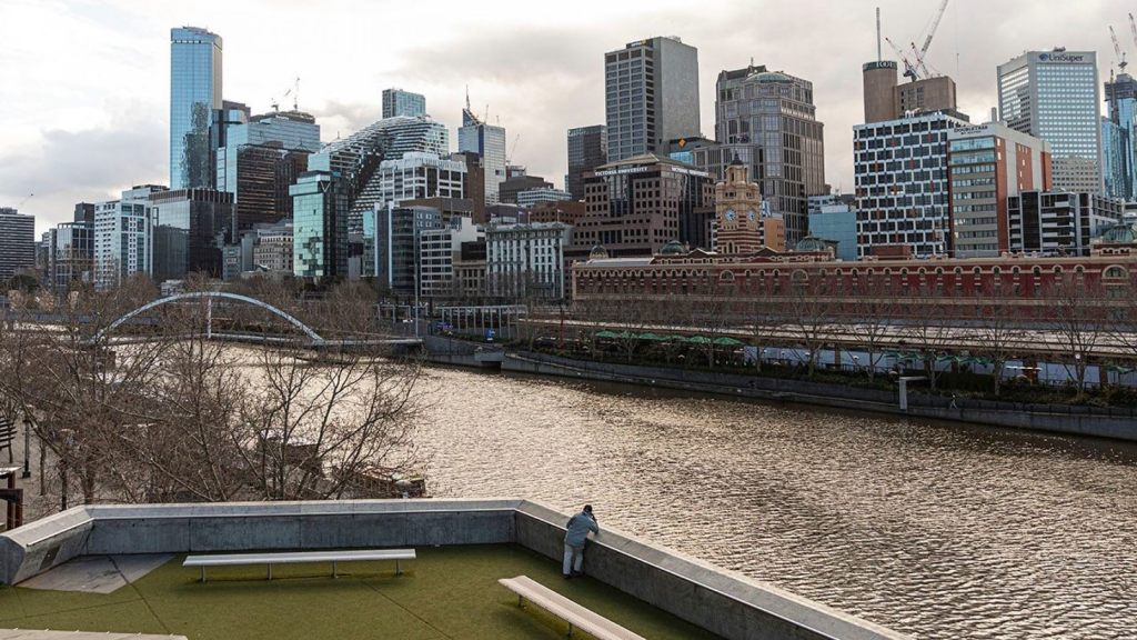 A lone man looks out toward the Yarra River and the empty Central Business District during lockdown in Melbourne, the captial city of Victoria state in Australia, on Aug. 5.