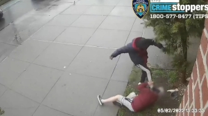 In this still image taken from surveillance video, the suspect stomps on the victim's head. (NYPD CrimeStoppers)
